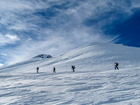 Ascent of a group of climbers on the snowy mountain の写真素材