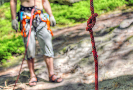 The man is ready to belay a climber 