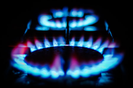 Blue flames of a gas stove in the dark. selective focus.