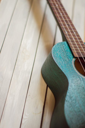 ukulele on a wooden background. shallow depth of field.