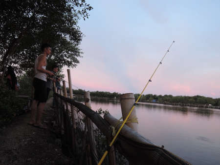 Male fishing in a fish pondのeditorial素材