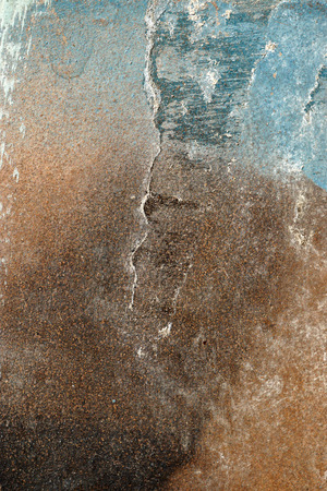 Small part of plastered hoarse,scratched and peeled surface area with blue and brown paint -Abstract background-Close upの写真素材
