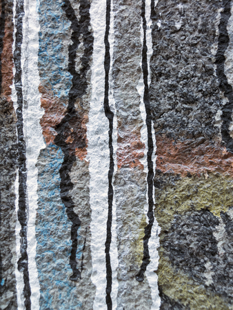 Spilled,dripping white,  black,  red, orange,  yellow and blue paint on a grey wall-abstract art backgroundの写真素材