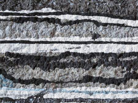 Spilled,dripping white,  black  and blue paint on a grey wall-abstract art backgroundの写真素材