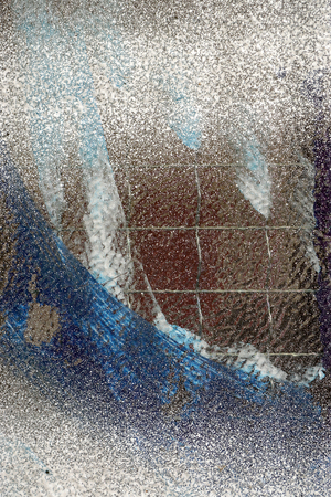 Reinforced, strengthened glass painted with white, blue and black paint-abstract
background-closeupの写真素材