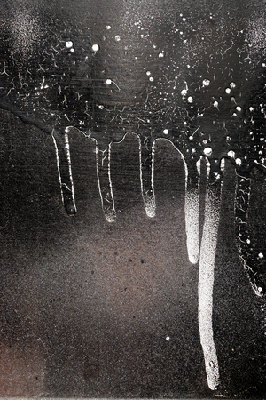 Rust-covered fence  with dripping black and white paint -  grunge iron textured abstract backgroundの写真素材