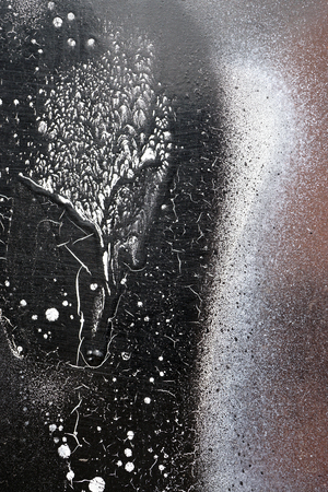Rust-covered fence  with dripping black and white paint -  grunge iron textured abstract backgroundの写真素材