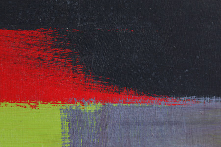 Stroke of a brush with  black, green,grey and red   acrylic paint  on a dusty old metal fence - Textured abstract multicolour  background - Close upの写真素材