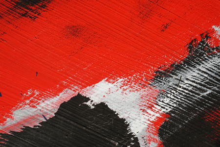 Stroke of a brush with  white,black and red  acrylic paint  on a dusty old metal fence - Textured abstract multicolour  background - Close up 4の写真素材