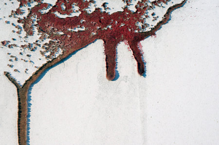 Close up,macro photography of dripping, runny red color on rough,grungy, dirty metal fence with interesting, intensive shadows from the cracked paint Abstract textured background with space for copy or textの写真素材