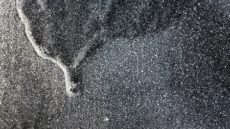 Dripping,runny white grey and black paint on metal fence  Close up,macro image of...