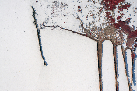 Close up,macro photography of dripping, runny red color on rough,grungy, dirty metal fence with interesting, intensive shadows from the cracked paint 
Abstract textured background with space for copy or textの写真素材