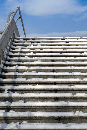 Empty snow and ice covered slippery concrete staircase with sky and clouds at the top.
Winter background, bottom view.
Place for copy text
の写真素材