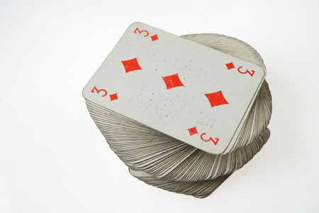 Stacked pile of old cards withÂ Three of Diamonds at the top.
Standard  French deck of 52 playing cards.
Isolated on white background. の写真素材