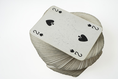 Stacked pile of old cards withÂ Two of Spades at the top.
Standard  French deck of 52 playing cards.
Isolated on white background. の写真素材