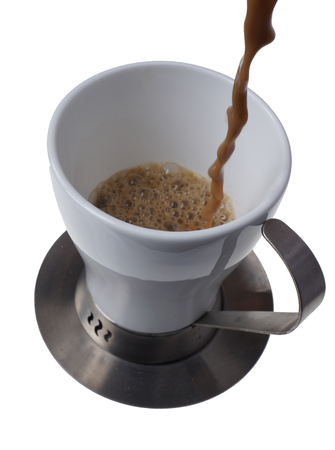 Pouring fresh coffee into a cup.
Home made CafÃ© Latte isolated on white. 
Black coffee background. Top view. Close up.の写真素材