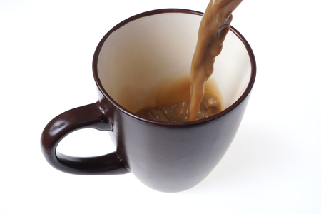 Pouring fresh coffee into a cup.
Home made CafÃ© Latte isolated on white. 
Black coffee background. Top view. Close up.の写真素材