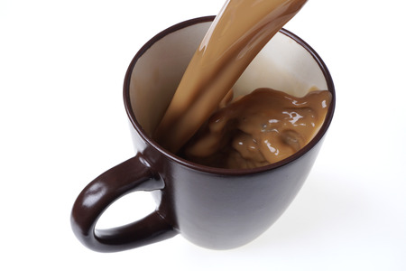 Pouring fresh coffee into a cup.
Home made CafÃ© Latte isolated on white. 
Black coffee background. Top view. Close up.の写真素材