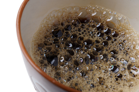 Macro of small bubbles in a coffee cup.
Black coffee background, texture.
Close up of espresso foam, froth.
Isolated on white.の写真素材