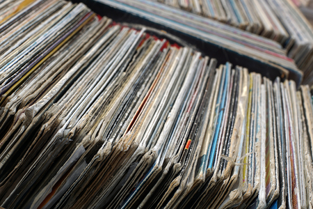 Selling old gramophone records. Stack of used vinyl records in covers put on sale.Vintage concept.Selective focus.Second hand concept.の写真素材