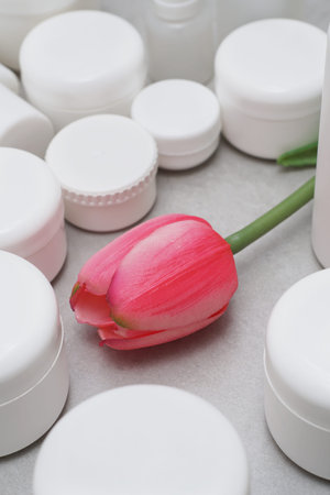 Mock-up.Empty bottles and jars for gel, lotion, cream.White plastic containers for skincare products without labels.Unbranded beauty product package.Green leaves.Cosmetic, pharmacy concept.の写真素材