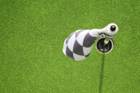 golf hole flag on a fieldの写真素材
