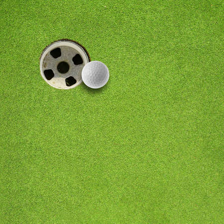golf ball hole on a fieldの写真素材