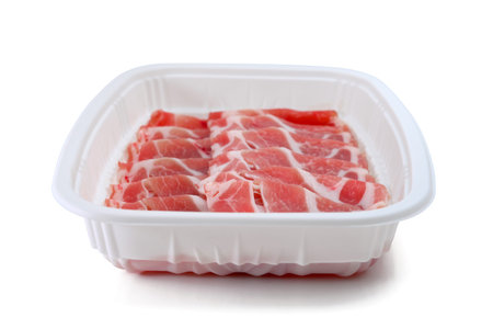 plastic pack of raw bacon slices with clipping pathの写真素材