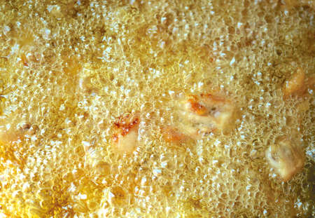 Fried chicken with boiling oilの写真素材