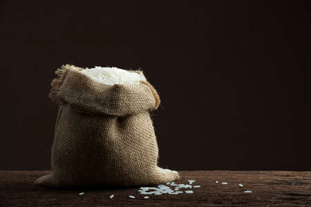 white rice in burlap sackの写真素材