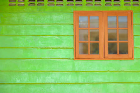ancient wooden window with green wallの写真素材