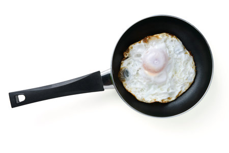 fried egg in a pan with clipping path