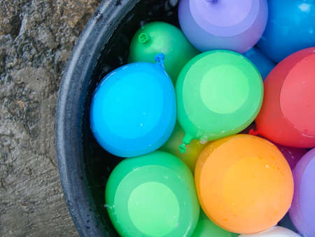 water balloons in a bucket with waterの写真素材