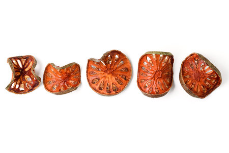row of dried quince on white background