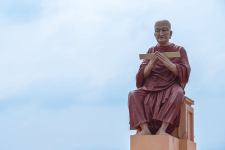 monk statue of buddhist recite scriptures