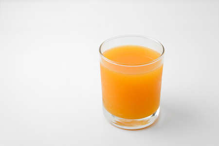 glass of orange juice isolated on whiteの写真素材