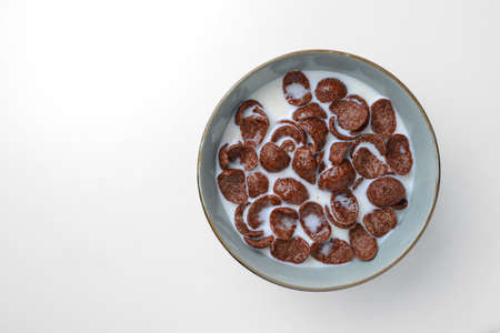 chocolate cereal with milk for breakfastの写真素材