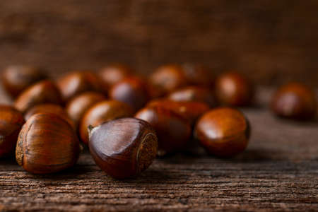 roasted chestnuts on wood backgroundの写真素材