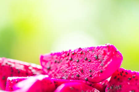 sliced dragon fruit on green backgroundの写真素材