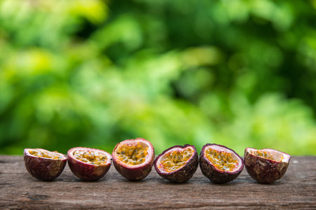 row of slice passion fruit on wooden tableの写真素材