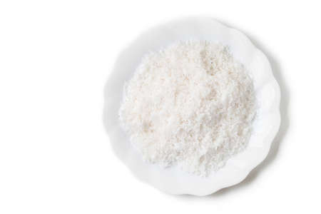 grated coconut in dish isolated on whiteの写真素材