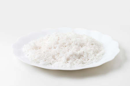grated coconut in dish isolated on whiteの写真素材
