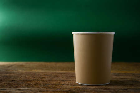 paper cup of coffee on wooden tableの写真素材