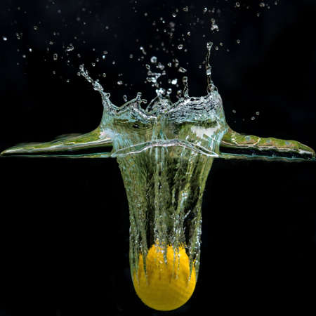 golf ball fall in waterの写真素材