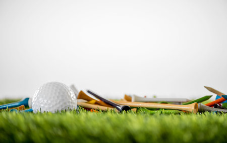 golf tees with ball on green fieldの写真素材