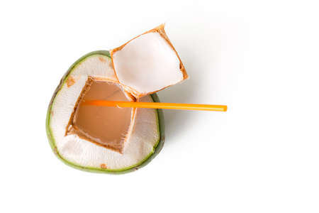 open fresh coconut with straw isolated on whiteの写真素材