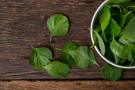 Cup of spinach on wooden tableの写真素材