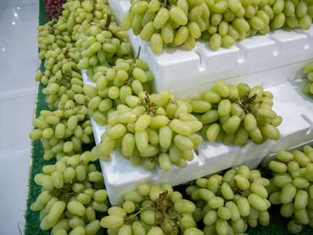 Bunch of grapes on the shelves in the marketの写真素材