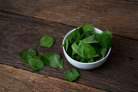 Cup of spinach on wooden tableの写真素材