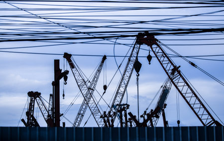 silhouette of construction cranes in store
